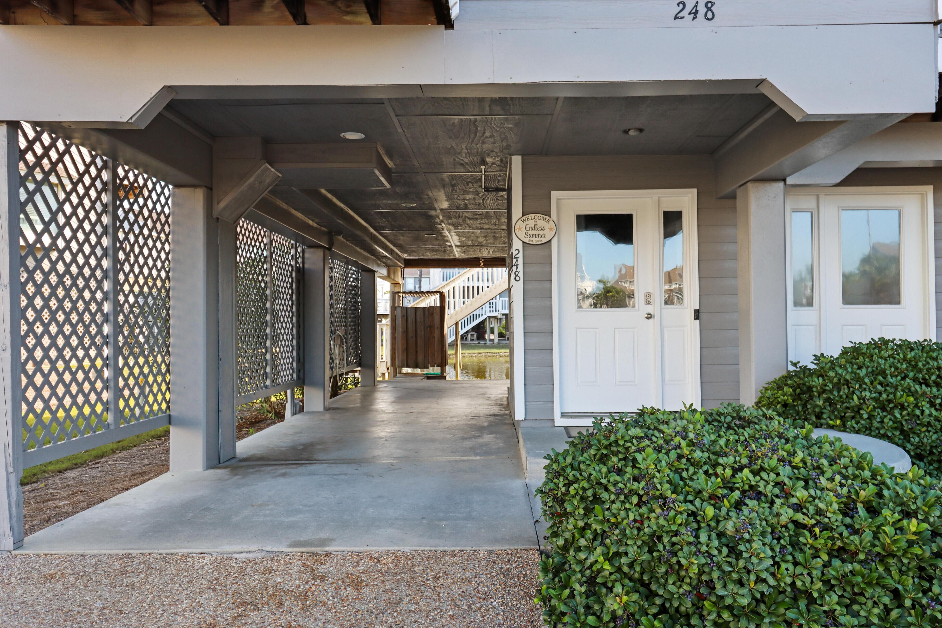 A covered walkway leading to a building with a sign reading "Welcome to Endless Summer."