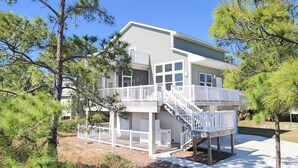 A two-story house with a balcony and a staircase leading to the upper floor.
