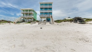 A beachfront building with multiple balconies and a staircase leading to the entrance. - Family Beach Escape Near Gulf and Bay (Cape San Blas)