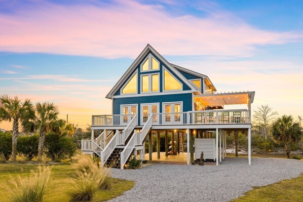 A two-story house with a balcony and a covered deck area.