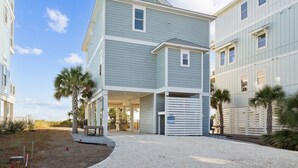 A two-story building with a covered patio and a garage.