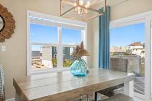 Enjoy a serene view of the residential area and beach from this room's large window.