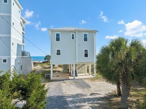 A two-story beachfront house with a covered porch and a view of the ocean. - Vista Blue - Gulf-Front Home with Private Beach Access and Sweeping Views! (Indian Pass)