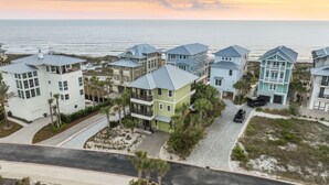 A coastal residential area with houses featuring balconies and a view of the ocean.