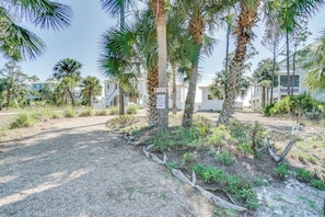A paved pathway lined with palm trees and a sign indicating a private driveway. - Beachfront with Private Boarkwalk to Beach (Indian Pass)