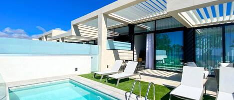 An infinity pool, sun loungers