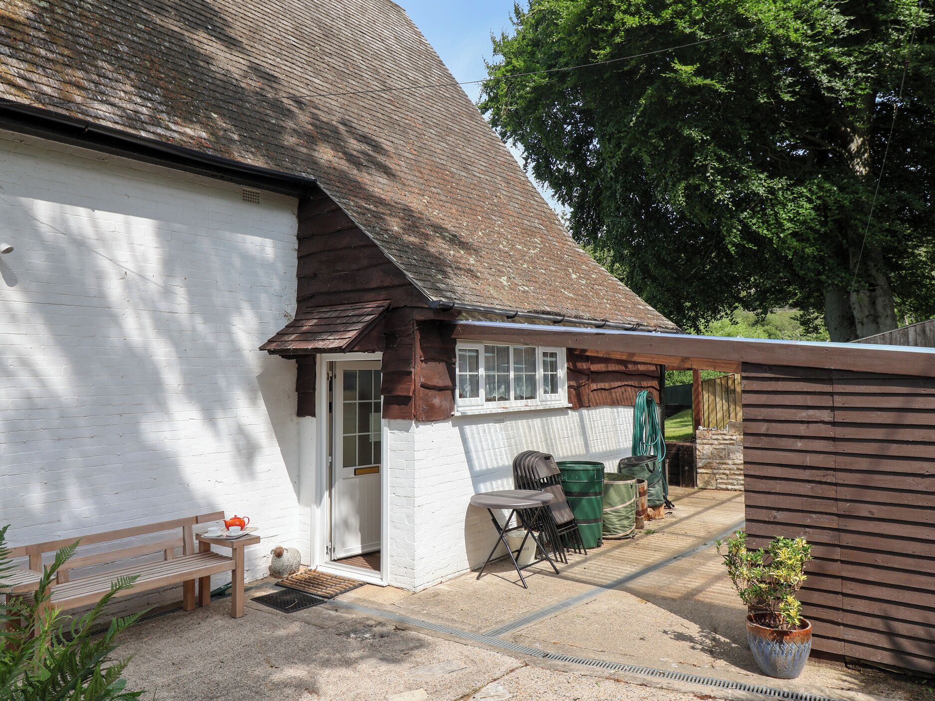 A rustic building with a white exterior and a sloped roof.