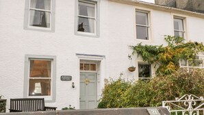 A white building with a sign reading "Raphael's Cottage."