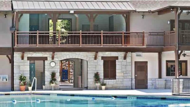 A two-story building with a swimming pool in front. - Beautiful Bright 6 bedroom home in the heart of Buckhead (Atlanta)