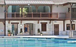 A two-story building with a swimming pool in front. - Beautiful Bright 6 bedroom home in the heart of Buckhead (Atlanta)