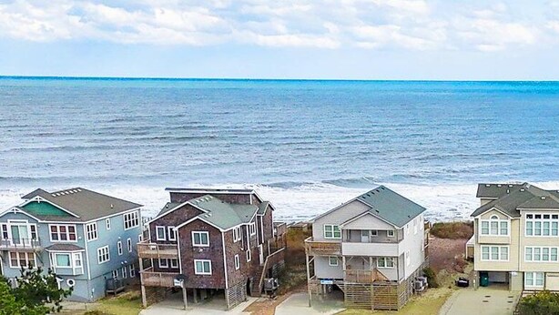 A coastal residential area with houses directly adjacent to the ocean. - Secret Spot: Steps to Beach, Dog-Friendly Duck (Duck)