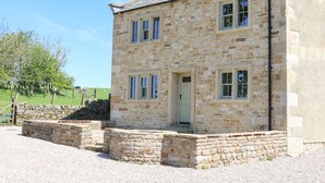 A stone building with a gabled roof, a front door, and multiple windows. - Lanshaw House (Lancaster)