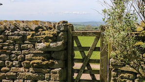 A stone wall with a wooden gate leading to a grassy area. - Lanshaw House (Lancaster)
