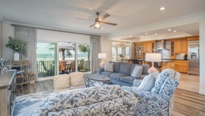 A spacious living area with a large sofa, a coffee table, and a dining area with a view of the ocean. - 29 Turtle Lane Club: BESTNEST by Beverly Serral OCEANFRONT (Hilton Head Island)