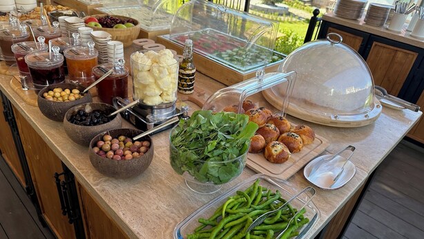A buffet with various food items and condiments. - Oikos Bozcaada (Bozcaada)
