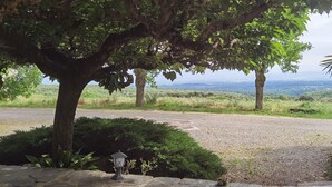 A paved path leading to a scenic overlook with a view of distant hills and a clear sky. - Domaine de La Calm: In a nature park with breathtaking views of the Pyrenees (Villardonnel)