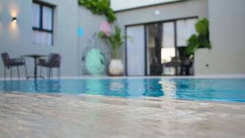 Outdoor pool, open 9:00 AM to 6:00 PM, pool loungers