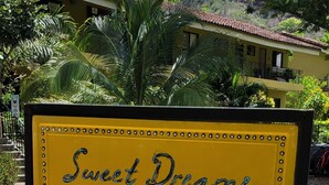 A sign with the text "Sweet Dreams" in a yellow frame with black trim.