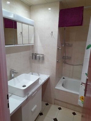 Combined shower/tub, hair dryer, towels, toilet paper