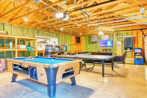 A recreational room with a pool table, ping pong table, and various gaming machines. - Antler Ridge: 3BDR w/ Hot Tub & Game Room (Penn Forest Township)