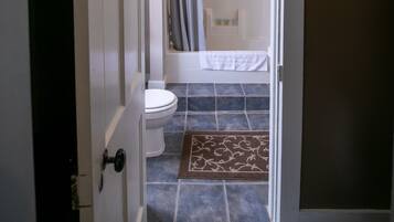 Ein Badezimmer mit Toilette, Dusche und Handtuchhalter.