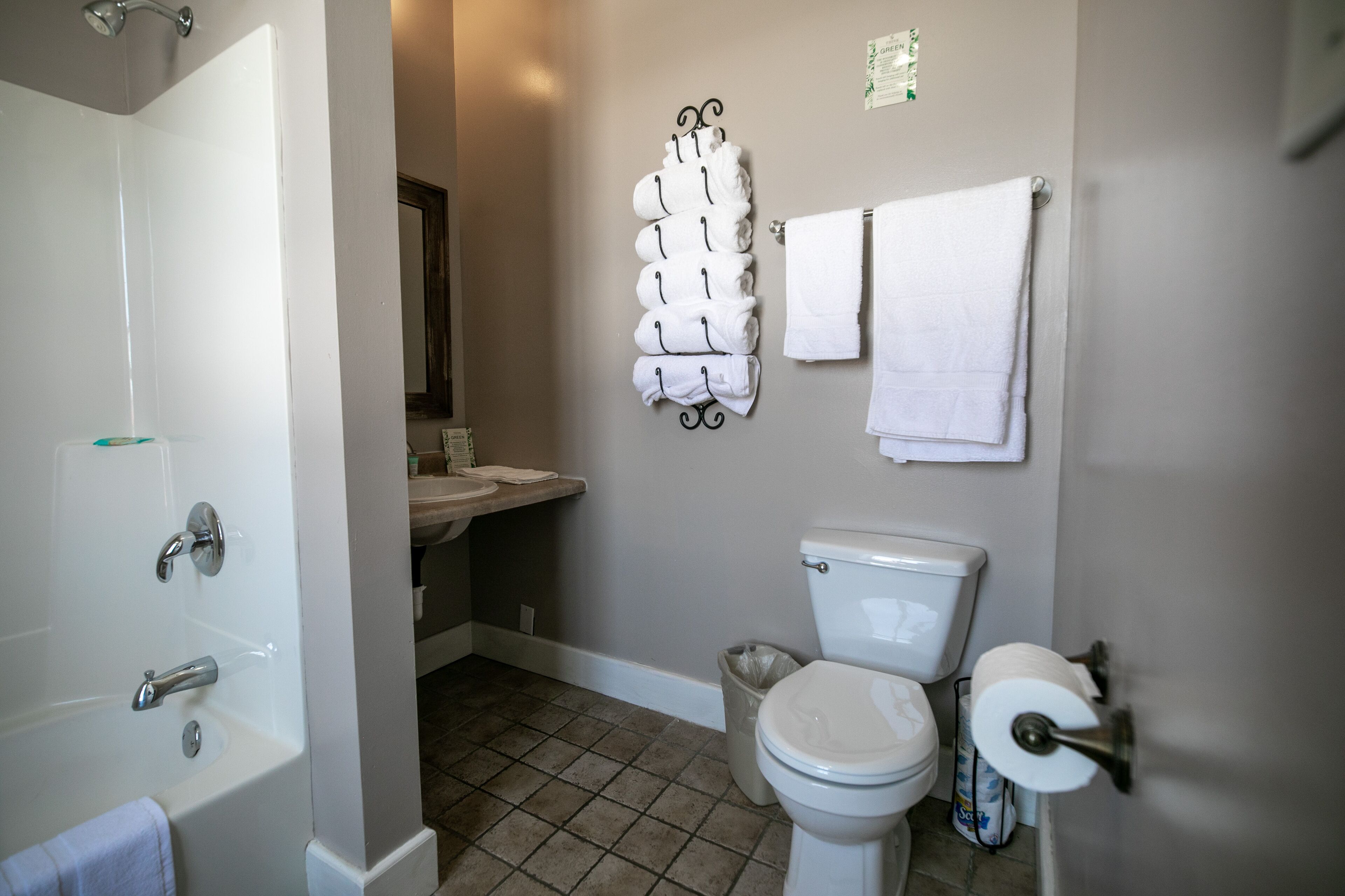 A bathroom with a bathtub, toilet, and sink.