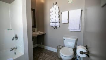 A bathroom with a bathtub, toilet, and sink.