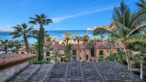 A coastal hotel with a view of the sea, palm trees, and traditional architecture. - Special Rates All Sumer Long, Corner 2 Bd Condo at Hacienda Beach Club!! (Cabo San Lucas)