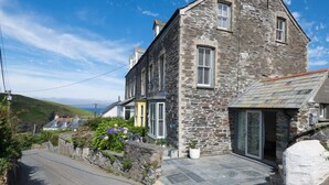 A stone house with a paved driveway and a small garden. - Albany (Port Isaac)