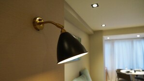 A wall-mounted lamp with a curved arm and a black shade. - Real Life Kudanshita Posh 1-bedroom 5pax 3mins sub (Tokyo)