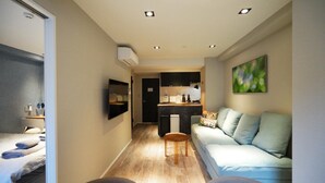 A compact living space with a kitchenette, a sofa, a dining area, and a bed. - Real Life Kudanshita Posh 1-bedroom 5pax 3mins sub (Tokyo)