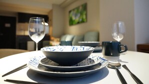 A dining table with a bowl, plates, cutlery, and a glass of water. - Real Life Kudanshita Posh 1-bedroom 5pax 3mins sub (Tokyo)