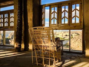 Enjoy a view of the historical site from the comfort of this room, featuring large windows and a traditional design.
