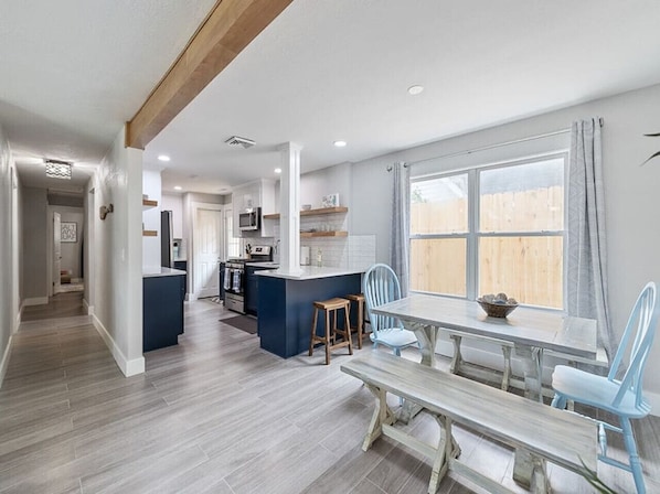 Modern kitchen with central island and dining area, perfect for cooking and socializing.