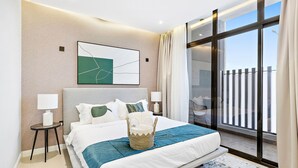 A modern hotel room with a large bed, a view of the city, and a cityscape painting on the wall. - Mabaat - Al Malqa - 384 (Riyadh)
