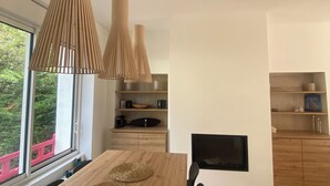 A modern kitchen with wooden cabinets, a built-in oven, and a flat-screen TV. - 4 bedroom villa in la baule-escoublac (La Baule-Escoublac)