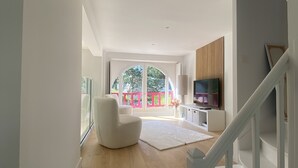 A modern interior with a staircase leading to a balcony. - 4 bedroom villa in la baule-escoublac (La Baule-Escoublac)