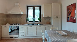 Enjoy cooking in this well-equipped kitchen with a central island, gas stove, and oven, perfect for preparing meals.