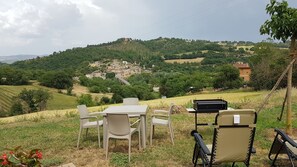 Enjoy meals al fresco amidst rolling hills and a charming village view.