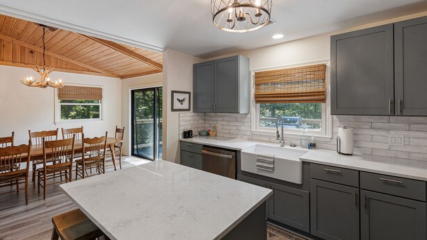 A modern kitchen with grey cabinets, a marble island, and a pendant light. - Private Renovated home 1.5 Miles to downtown Highlands!  (Highlands)
