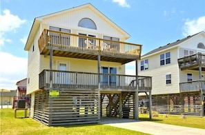 A two-story building with a balcony on the upper floor. - 4 bedroom, short walk to the beach in Kill Devil Hills! (Kill Devil Hills)