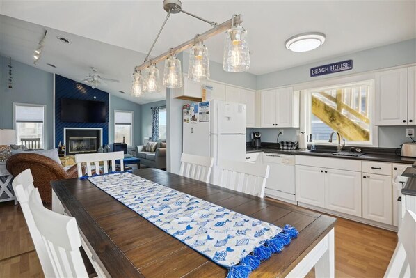 Enjoy cooking in this kitchen with a dining table and ceiling fan.