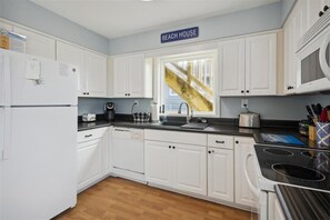Enjoy cooking in this fully equipped kitchen with a refrigerator, coffee maker, kettle, and toaster.