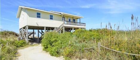 Enjoy stunning beach views from the elevated deck of this beachfront property.