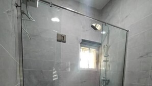A modern bathroom with a glass-enclosed shower, a white sink, and a toilet. - lovely 4bedroom in a well-secured estate (Lagos)