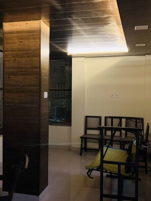 Relax in a stylish space with a wooden column, seating area, and large window.