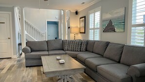 A living room with a sectional sofa, a coffee table, and a ceiling fan. - Guest-Favorite Rehoboth Beach Retreat:10/10 Reviews - Book early! (Rehoboth Beach)