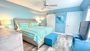 A bedroom with a bed, a desk, a TV, a ceiling fan, and a wardrobe. - Guest-Favorite Rehoboth Beach Retreat:10/10 Reviews - Book early! (Rehoboth Beach)