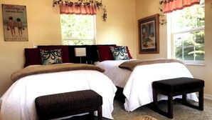 A bedroom with two beds, a nightstand, a window with a view of greenery, and a poster on the wall. - OCTOPUS SUITE, fire pit, BBQ, wildlife viewing platform, shared oceanfront deck. (Brookings)