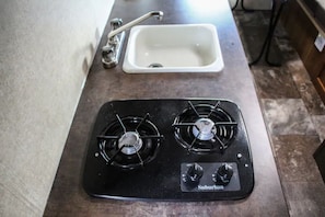 Kitchen area with a gas stove and sink.